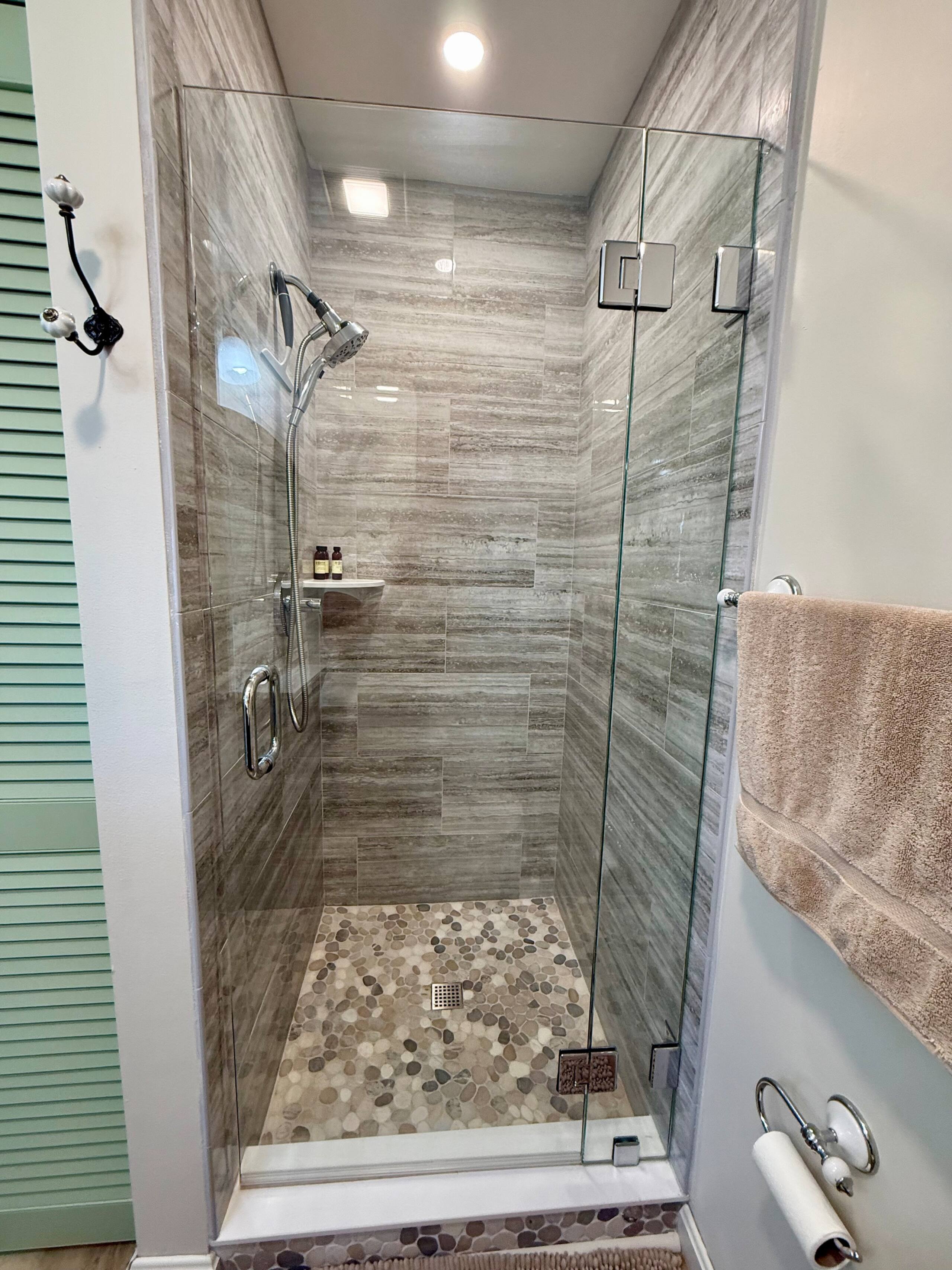 Bathroom shower detail with tile and amenities