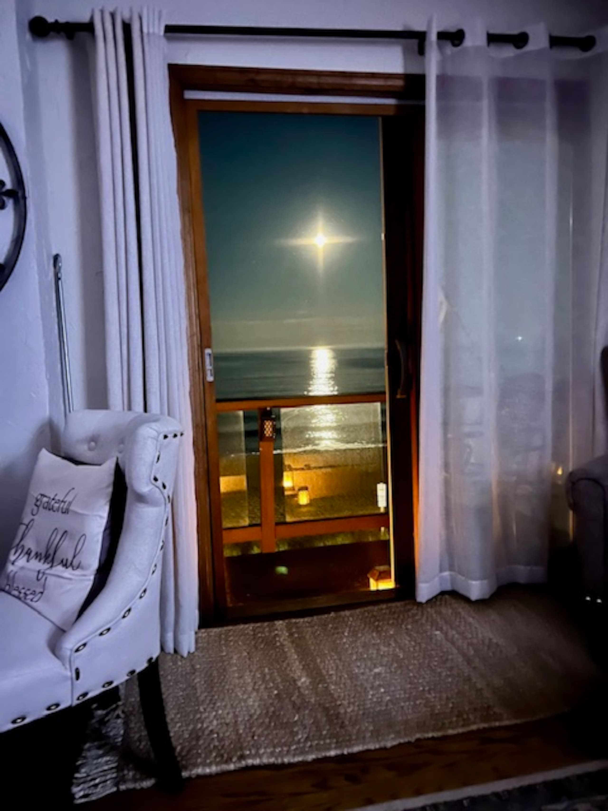 Moonrise over the ocean seen from the living room deck