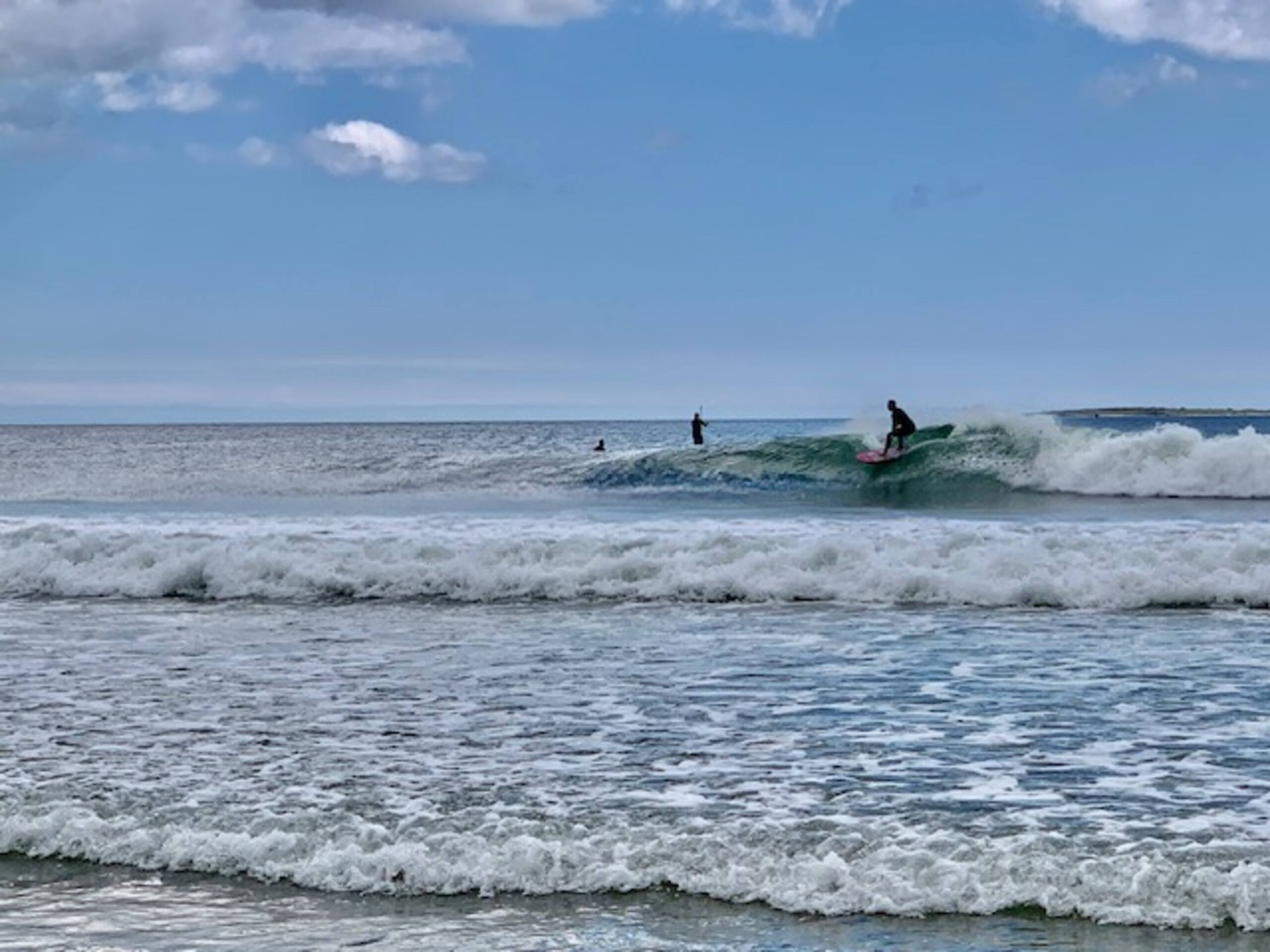 Surfer riding a wave at Old Orchard Beach