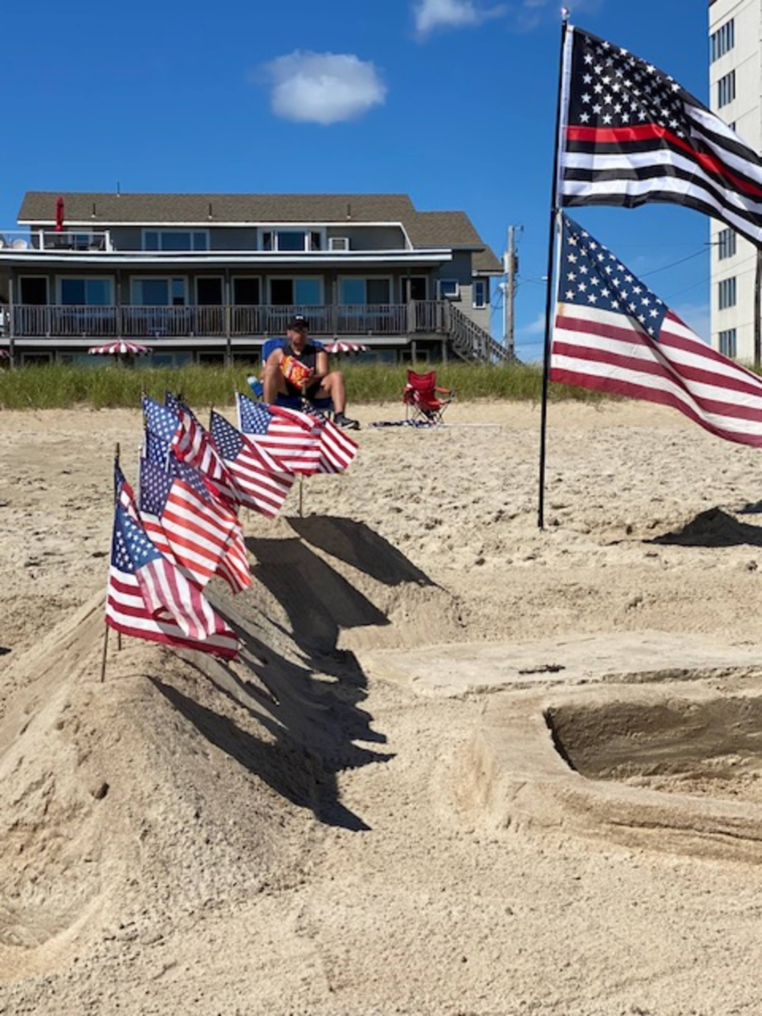 Patriotic flags planted in the sand at Old Orchard Beach