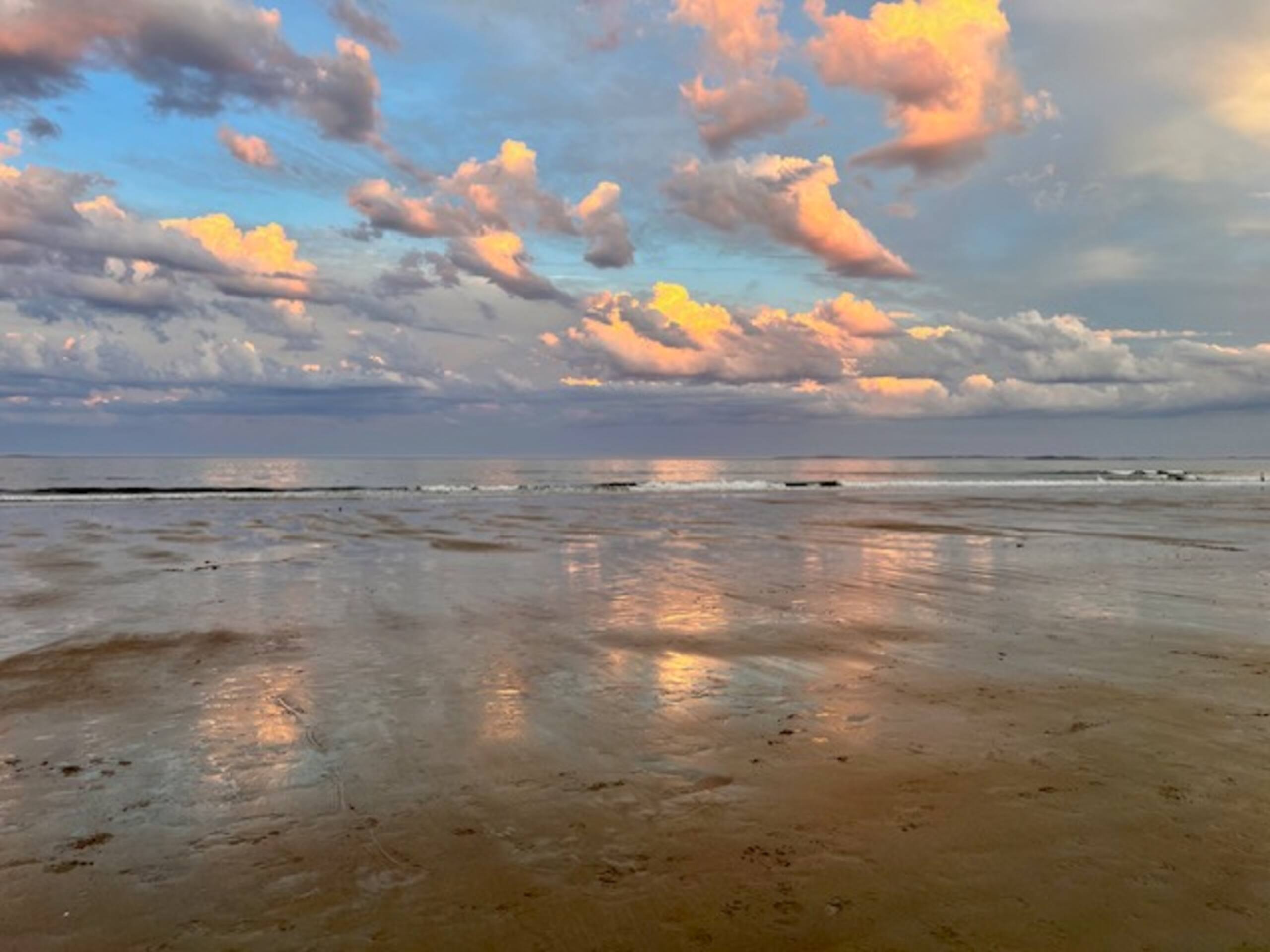 Sunset reflecting on the wet sand