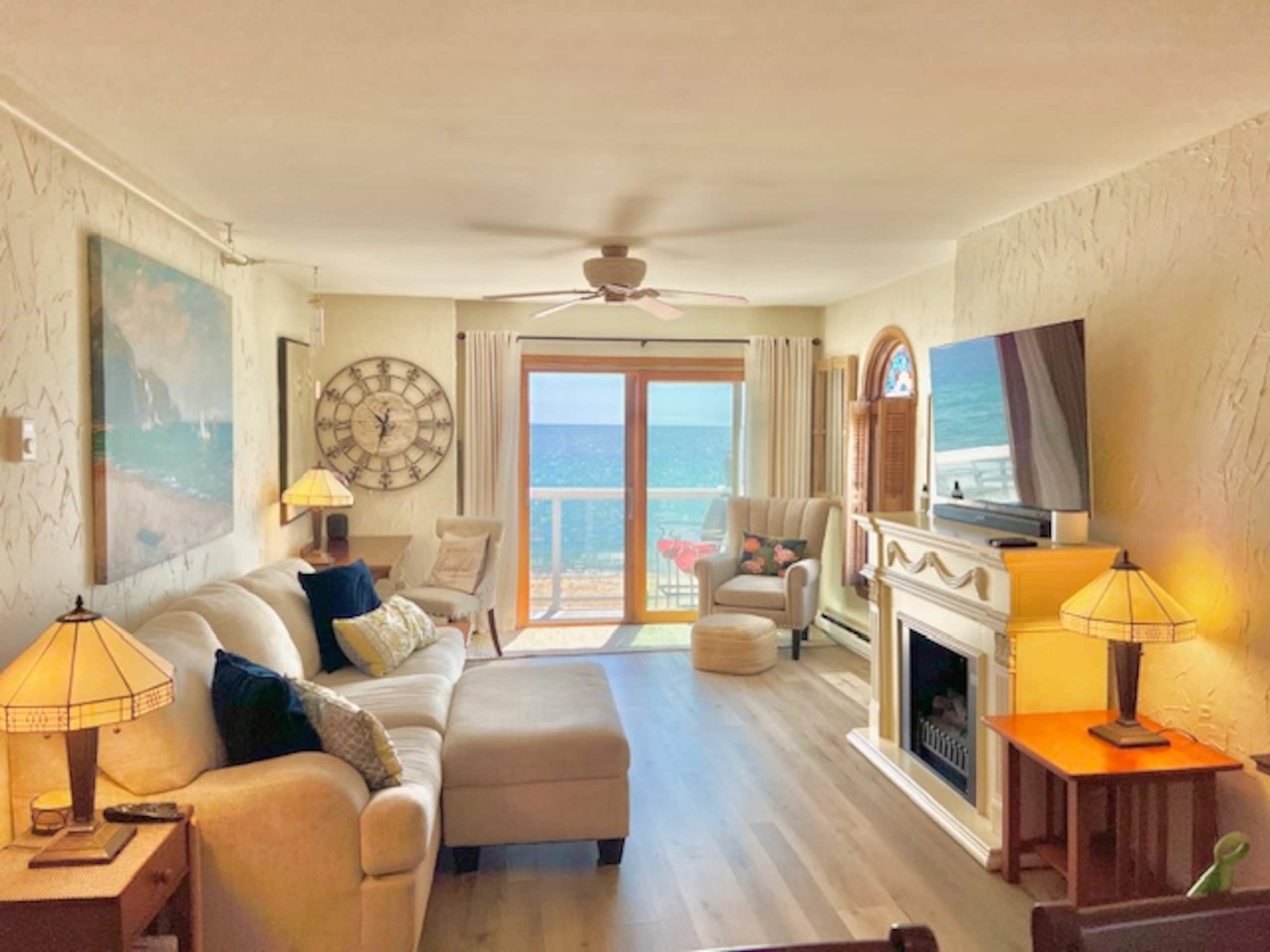 Wide view of the living room with ocean-view sliding doors
